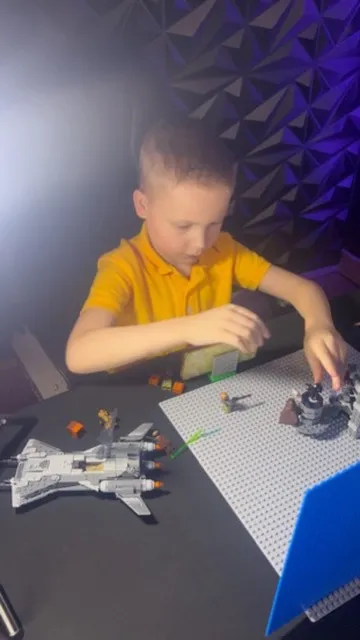 CJ animating a brick spaceship battle in a purple studio